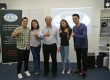 A group of people smiling and giving thumbs up, promoting Be the Voice Academy in Singapore.